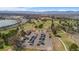 Aerial view of community near highway and golf course featuring mature trees and mountain views at 4625 W 50Th Ave # 110, Denver, CO 80212