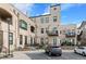 Building with balconies and patios, showing a back entrance and parking spaces at 4625 W 50Th Ave # 110, Denver, CO 80212