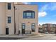 Modern building exterior with clean lines, an arched window, and a small front patio at 4625 W 50Th Ave # 110, Denver, CO 80212