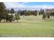 Expansive view of the lush green golf course, with mountain views in the distance, providing a scenic and recreational backdrop at 4625 W 50Th Ave # 110, Denver, CO 80212