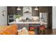 Modern kitchen with stainless steel appliances, gray cabinets, and center island with seating at 4625 W 50Th Ave # 110, Denver, CO 80212