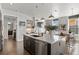 Open concept kitchen with large island, stainless steel appliances, and views of the living area at 4625 W 50Th Ave # 110, Denver, CO 80212