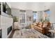 Bright living room featuring a fireplace, comfortable seating, and large windows with natural light at 4625 W 50Th Ave # 110, Denver, CO 80212