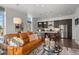 Open concept living room with comfortable seating and view into the kitchen area at 4625 W 50Th Ave # 110, Denver, CO 80212