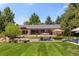 Expansive backyard oasis with a deck, water feature, and stunning views at 6200 Charrington Dr, Cherry Hills Village, CO 80111