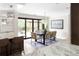 Kitchen dining area with table and chairs, leading to patio at 6200 Charrington Dr, Cherry Hills Village, CO 80111