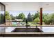 Kitchen sink with a view of the backyard pool and patio at 6200 Charrington Dr, Cherry Hills Village, CO 80111