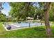 Relaxing pool area with a tree-shaded swing and ample green space at 6200 Charrington Dr, Cherry Hills Village, CO 80111