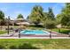 Spacious pool with surrounding deck and lush landscaping at 6200 Charrington Dr, Cherry Hills Village, CO 80111