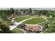 Aerial view of a community park with a large lawn, walking paths and playground at 17125 W 91St Ln, Arvada, CO 80007