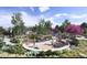 Community playground surrounded by lush landscaping and walking paths at 17125 W 91St Ln, Arvada, CO 80007