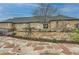 A stone house boasts a large backyard, complete with a stone patio and elevated garden beds at 15280 Bannock St, Broomfield, CO 80023