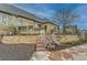 A stone house boasts a large backyard, complete with a stone patio, stairs, and elevated garden beds at 15280 Bannock St, Broomfield, CO 80023