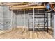 Unfinished basement space with wood floors, exposed ceiling, and shelving unit at 15280 Bannock St, Broomfield, CO 80023