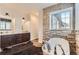 Bright primary bath with double vanities, soaking tub, and stone accent wall at 15280 Bannock St, Broomfield, CO 80023
