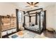 A bedroom features a unique bed frame, hardwood floors, and natural light from two windows at 15280 Bannock St, Broomfield, CO 80023