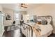 Bedroom with a ceiling fan, hardwood floors, and access to an en-suite bathroom and closet at 15280 Bannock St, Broomfield, CO 80023