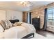 Bedroom features a stone accent wall, hardwood floors, and natural light at 15280 Bannock St, Broomfield, CO 80023