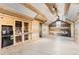 Large bonus room featuring built-in storage, wooden walls, and vaulted ceiling with ample lighting at 15280 Bannock St, Broomfield, CO 80023
