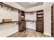 A spacious walk-in closet with custom shelving, drawers, and hardwood floors for organized storage at 15280 Bannock St, Broomfield, CO 80023