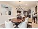 Dining area showcasing modern chandelier and table, surrounded by a beautiful kitchen and living space at 15280 Bannock St, Broomfield, CO 80023