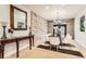 Elegant dining room features stone accent wall, modern chandelier, and hardwood table with seating at 15280 Bannock St, Broomfield, CO 80023
