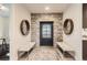 Inviting entryway with stone accent wall, decorative mirrors, tile flooring, and bench seating at 15280 Bannock St, Broomfield, CO 80023
