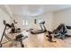 Spacious exercise room with various workout machines and hardwood floors at 15280 Bannock St, Broomfield, CO 80023
