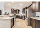 Modern kitchen boasts dark wood cabinets, stainless steel appliances, and granite countertops at 15280 Bannock St, Broomfield, CO 80023
