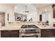 Contemporary kitchen design with stone backsplash, stainless steel gas range, and granite countertops at 15280 Bannock St, Broomfield, CO 80023