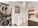 Well-equipped laundry room featuring a washer and dryer, sink, and storage cabinets at 15280 Bannock St, Broomfield, CO 80023