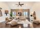 Bright living room boasting a stone accent wall, hardwood floors, and an open layout with lots of natural light at 15280 Bannock St, Broomfield, CO 80023