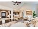 Open-concept living area seamlessly connects to the kitchen, with a stone accent wall and modern decor at 15280 Bannock St, Broomfield, CO 80023