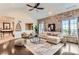 Stylish living room offers stone wall, modern decor, comfortable seating, and plenty of light at 15280 Bannock St, Broomfield, CO 80023