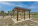 Captured is the pergola in the backyard, complete with benches and a fire pit in the backyard at 15280 Bannock St, Broomfield, CO 80023