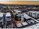 Aerial view of a modern home in a residential neighborhood with rooftop deck during sunset at 1933 Grove St, Denver, CO 80204