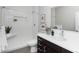 Modern bathroom features a walk-in shower, dark cabinets, and a white countertop at 1933 Grove St, Denver, CO 80204