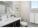 Bright bathroom with a dark vanity, white countertops, and modern fixtures at 1933 Grove St, Denver, CO 80204