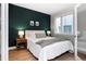 A serene bedroom featuring an accent wall, a cozy bed, and soft lighting for a relaxing ambiance at 1933 Grove St, Denver, CO 80204