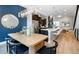 Bright dining area with a modern table and chairs, complemented by an open kitchen with stainless steel appliances at 1933 Grove St, Denver, CO 80204