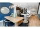 Open-concept dining room features a modern table, chairs, and stylish lighting, flowing into the kitchen at 1933 Grove St, Denver, CO 80204