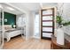 Inviting foyer with stylish wood door, light floors, and a glimpse into a bedroom beyond glass doors at 1933 Grove St, Denver, CO 80204