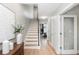 Inviting home hallway with sleek staircase leads to living spaces with light, airy feel at 1933 Grove St, Denver, CO 80204