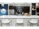 Open-concept kitchen featuring a large island with bar seating, pendant lights, and modern appliances at 1933 Grove St, Denver, CO 80204
