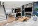 Open-concept living space featuring a modern kitchen, cozy living area, and elegant stairway access at 1933 Grove St, Denver, CO 80204
