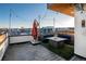 Bright rooftop deck with an umbrella, comfortable seating, and views of the neighborhood at 1933 Grove St, Denver, CO 80204