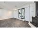 Basement features white brick fireplace, gray vinyl floors, and walkout access at 3353 S Glencoe St, Denver, CO 80222