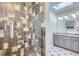 Modern bathroom featuring a tiled shower, skylight, and granite vanity at 3353 S Glencoe St, Denver, CO 80222