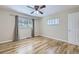 Bright bedroom with hardwood floors, a ceiling fan, and windows with coverings providing natural light at 3353 S Glencoe St, Denver, CO 80222
