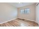 Cozy bedroom with wood floors, a neutral color scheme, and natural light at 3353 S Glencoe St, Denver, CO 80222
